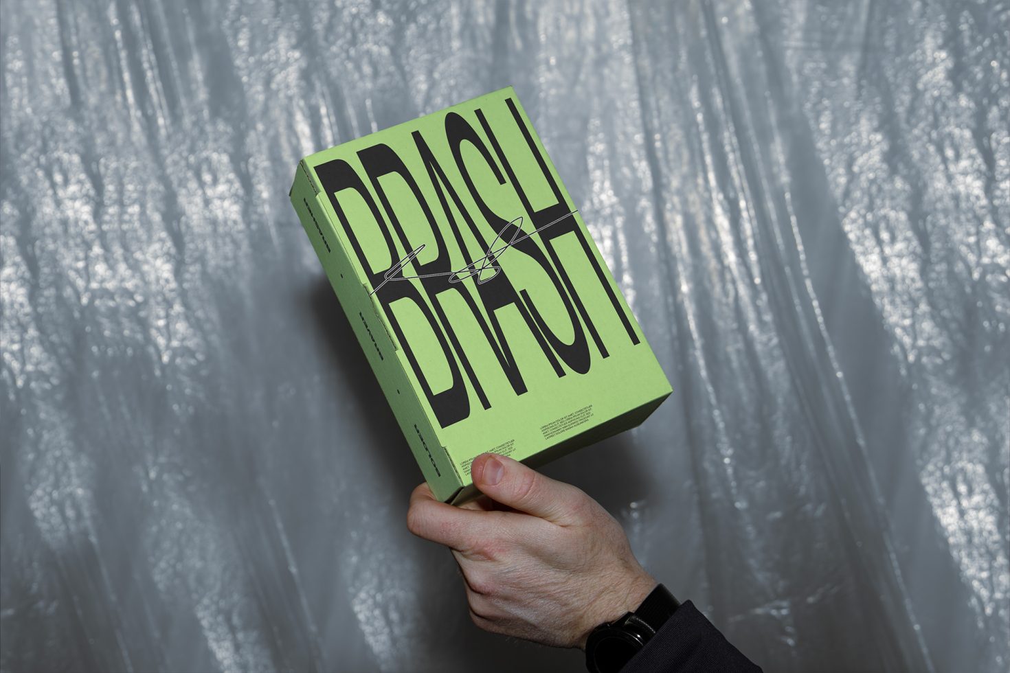 Person holding a book mockup with bold typography design on a textured background, perfect for designers' presentation materials.